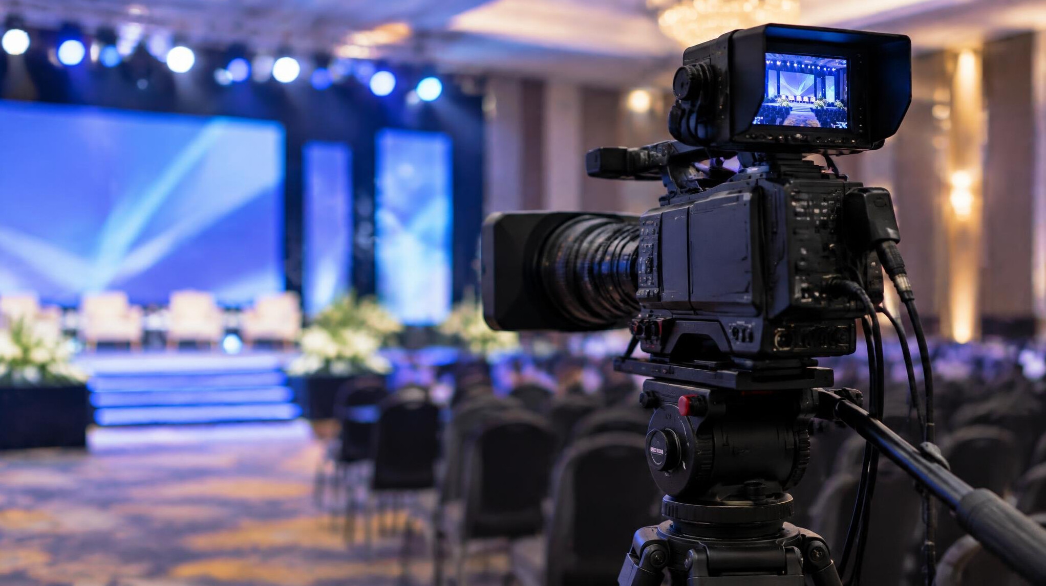 Professional broadcast camera on a tripod at an event