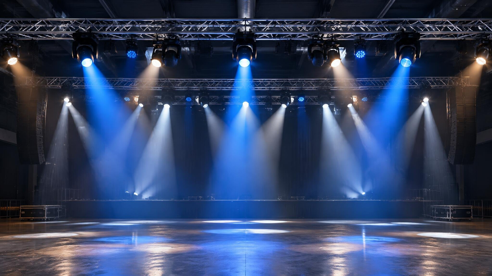 Stage lighting rig above an event floor
