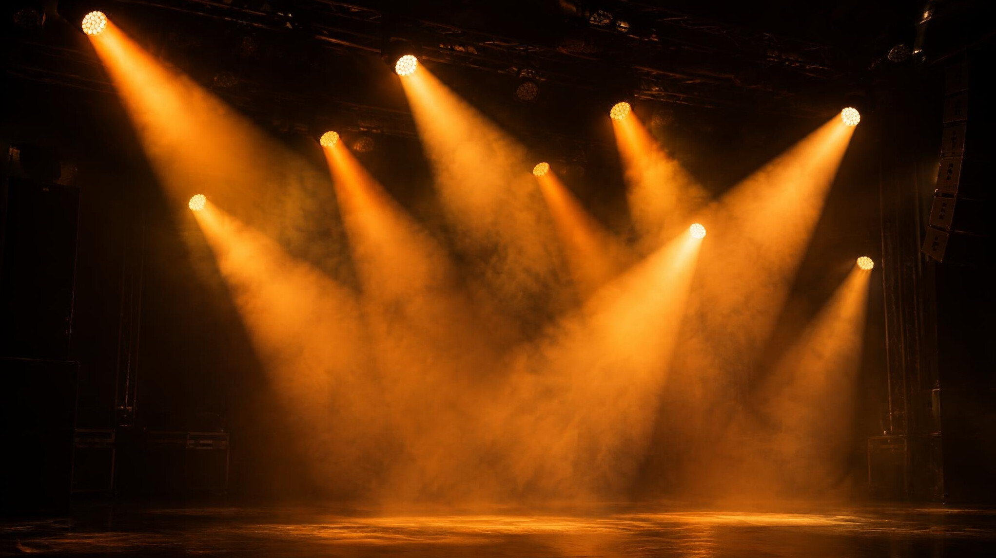 Warm stage spotlights shining through haze